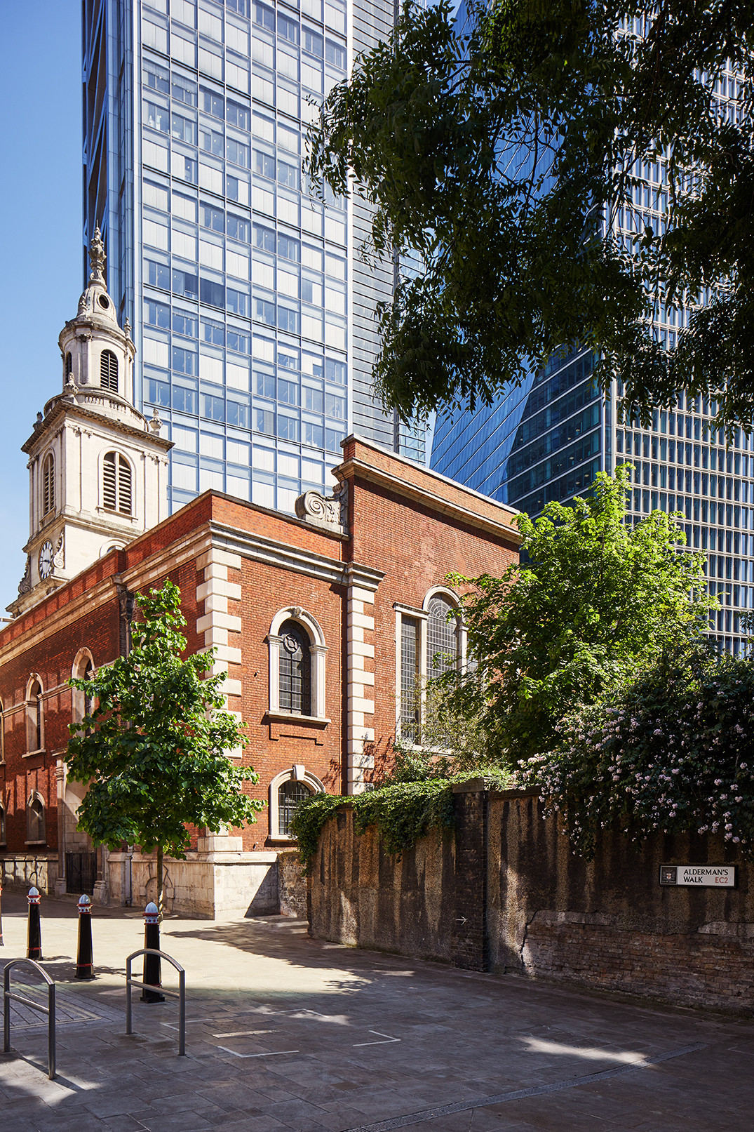 View of St Botolph-without-Bishopsgate Church surrounded by contemporary office buildings near MYO Liverpool Street.