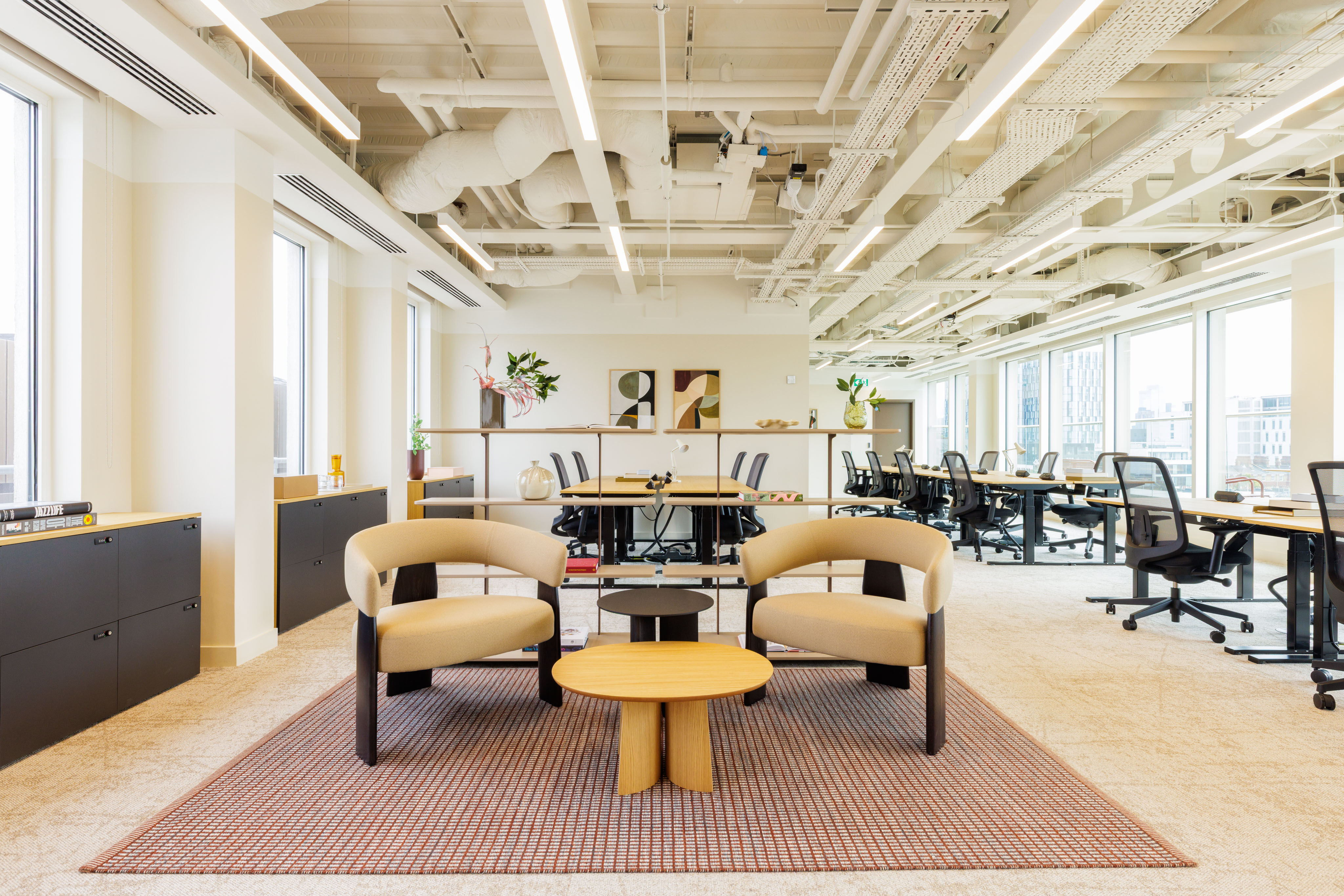 Open-plan workspace at MYO King's Cross featuring shared desks, breakout seating and abundant natural light.