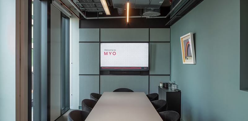 Modern meeting room at MYO Bankside equipped with presentation technology and seating for small teams.