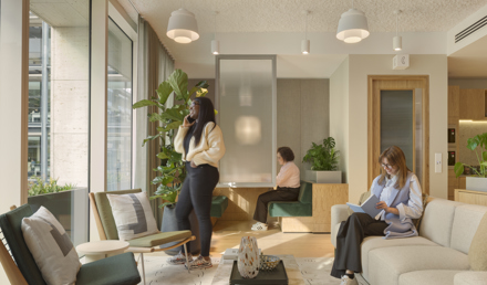 Three members using separate areas of MYO's modern workspace featuring comfortable seating and contemporary design.