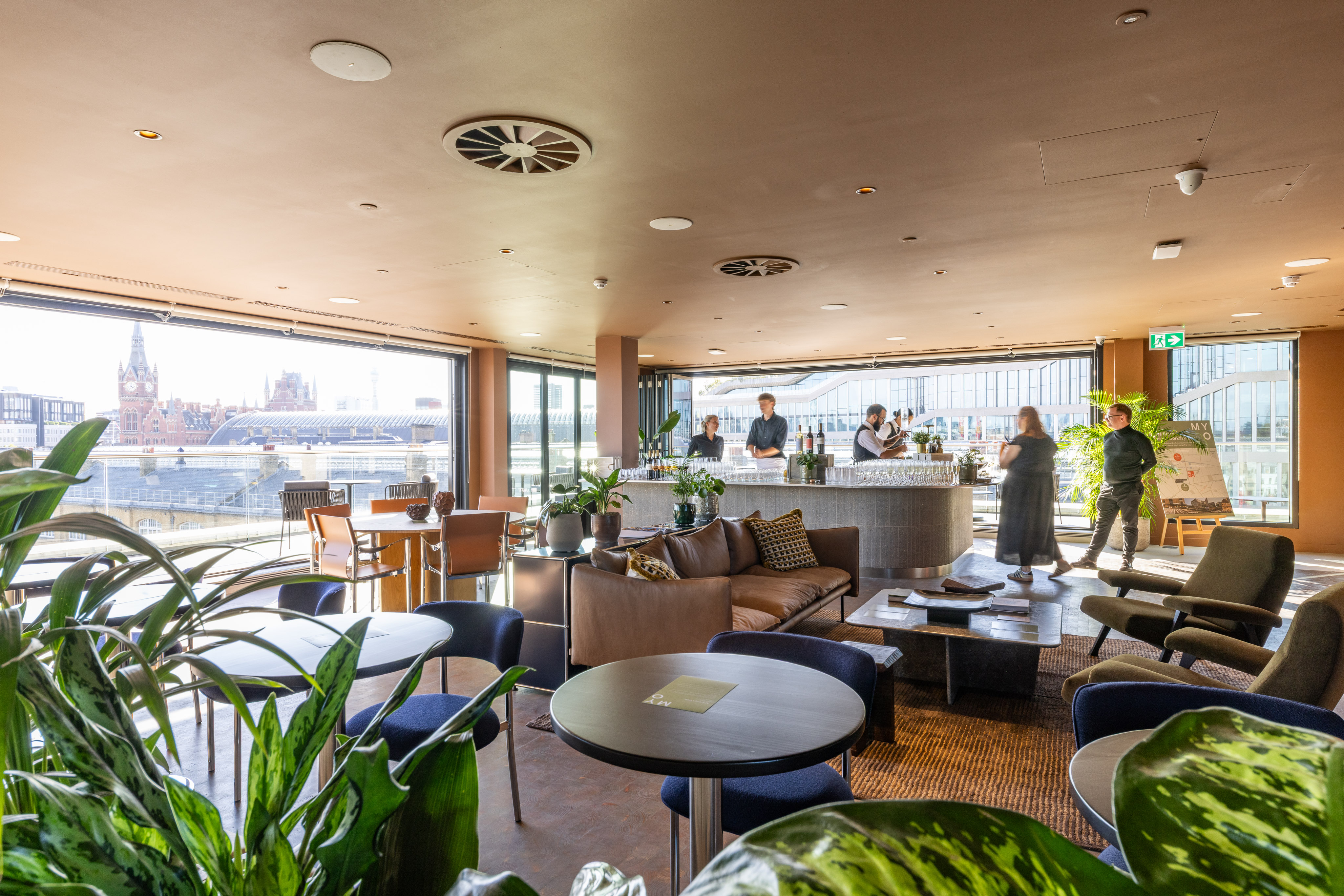 Lounge and hospitality space at MYO King's Cross featuring comfortable seating, a bar area and panoramic views across London.
