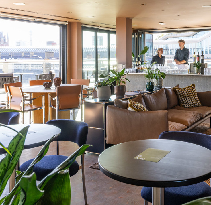 Lounge and hospitality space at MYO King's Cross featuring comfortable seating, a bar area and panoramic views across London.