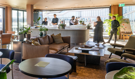 Lounge and hospitality space at MYO King's Cross featuring comfortable seating, a bar area and panoramic views across London.