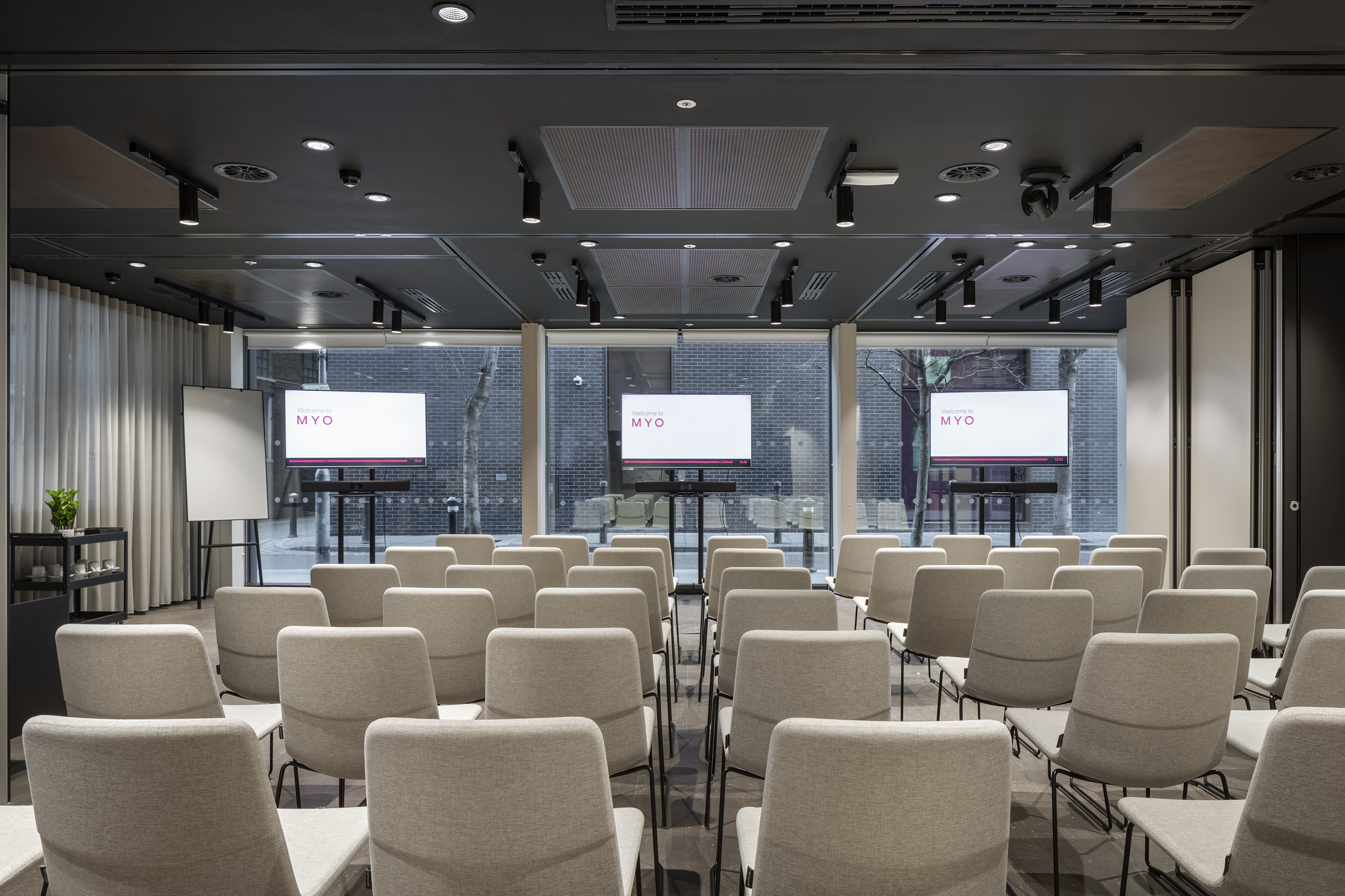 Event suite at MYO Bankside arranged in theatre style with presentation screens and seating.