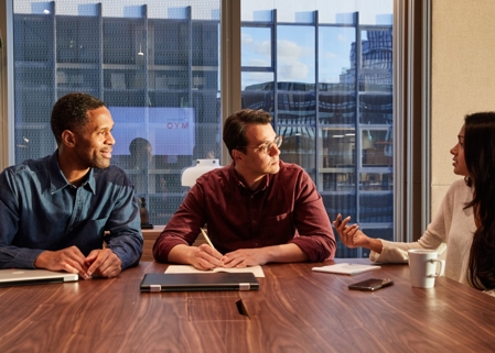 Three professionals meet in assembly meeting room 2