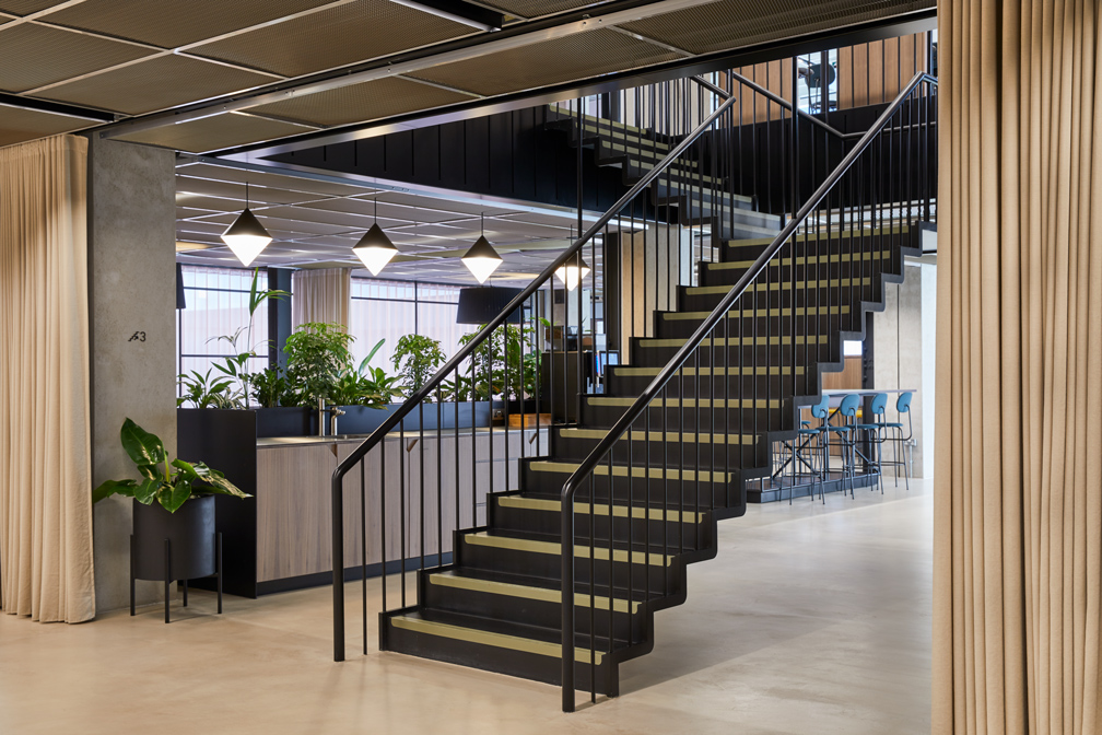 A modern, sleek staircase in the centre of MYO Victoria Street reception