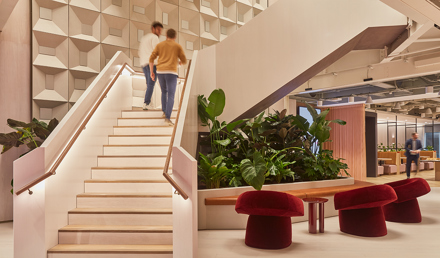 Members moving through MYO's contemporary workspace featuring statement staircases, lounge seating and integrated planting.