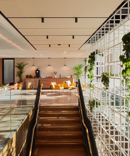 A stylish staircase leads to a bright, welcoming lounge space