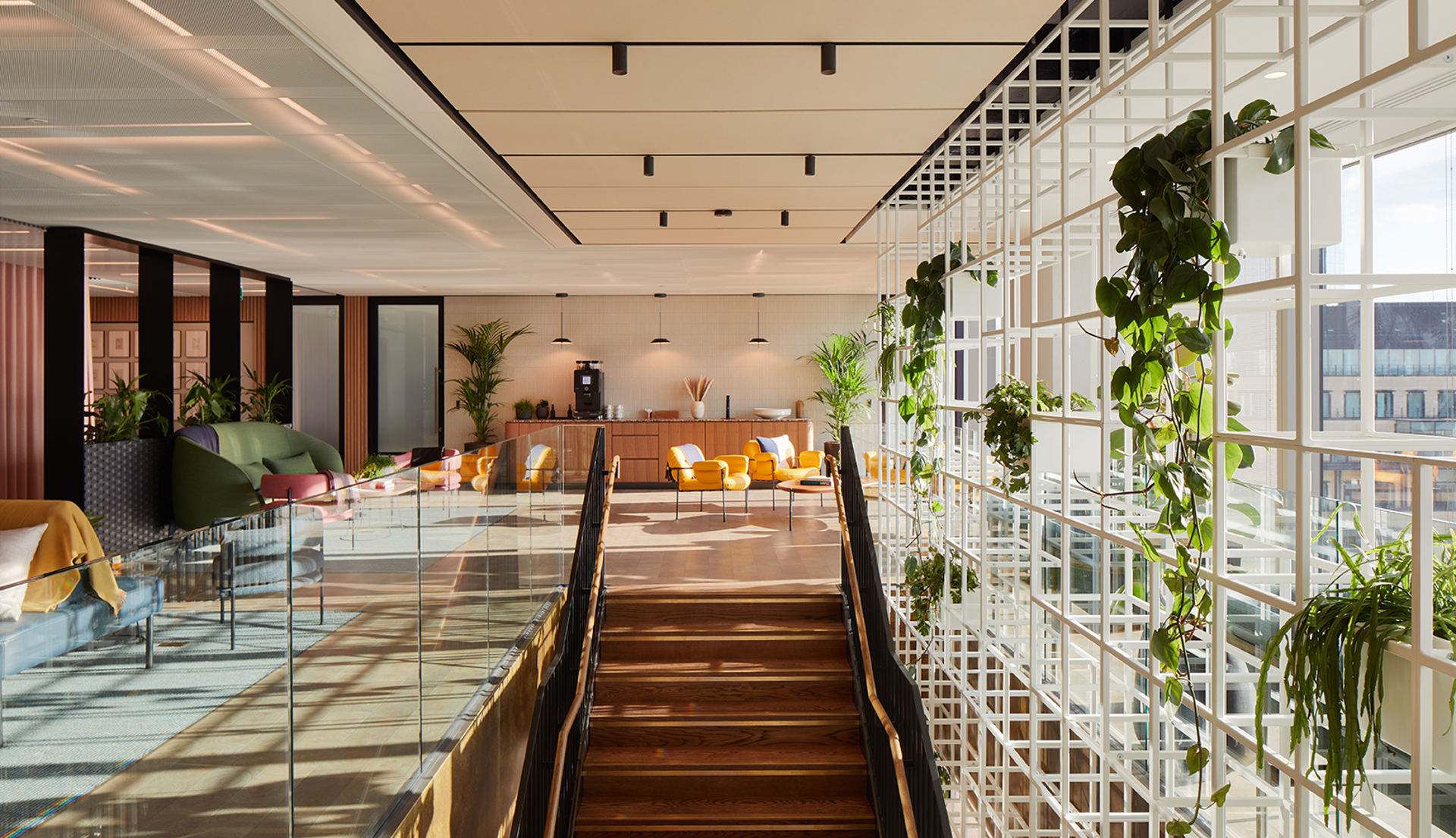 A stylish staircase leads to a bright, welcoming loounge space
